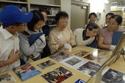 Flora Hsu, center, a volunteer at the Dole Institute of Politics, leads a tour of the institute in Mandarin Chinese during the institute's bilingual tour day June 16. Since opening in 2004, the institute has been host to bipartisan speakers and innovative programming.