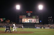 San Francisco's Barry Bonds hits his 756th career home run off Washington's Mike Bacsik. Looking on are home-plate umpire John Hirschbeck and Nationals catcher Brian Schneider. The ball can be seen flying out just to the left of the light tower on the right side Tuesday night in San Francisco.