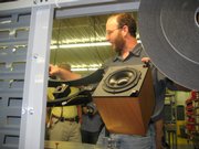 Paul Schmidt, electronic assembly lead for MartinLogan Ltd., shows off some of the company's handwork during a recent tour at the MartinLogan campus south of 20th and Delaware streets. The company's new president, Mike Lyons, plans to boost an emphasis on design and performance that includes catering to women by creating speakers that are more easily hidden in walls or ceilings.
