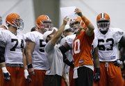 Cleveland quarterback Brady Quinn, right, goes over a play with teammates during training camp. Quinn will not start tonight's game against Kansas City but could move up the depth chart if Charlie Frye or Derek Anderson struggle.