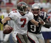 Tampa Bay Buccanears quarterback Jeff Garcia (7) is chased from the pocket by New England Patriots' Jarvis Green during the first quarter of the Buccanears' 13-10 preseason victory Friday night.