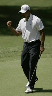 Tiger Woods pumps his fist as he birdies the fourth hole during the second round of the PGA Championship. Woods fired a 7-under-par 63 on Friday at Southern Hills Country Club in Tulsa, Okla.