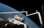 In this photo made available by NASA, Space Shuttle Endeavour and the shuttle's Remote Manipulator System/Orbiter Boom Sensor System are shown against the blackness of space and Earth's horizon during flight activities.