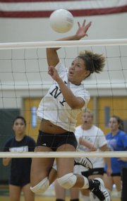 Free State high junior Taylor Manning jumps for an attempted spike during team drills. Fall sports team practices started Monday across the state.