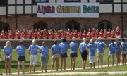 Kansas University’s Alpha Gamma Delta sorority members, in red, sing a song to prospective freshman greek recruits in this August 2007 file photo during recruitment week.