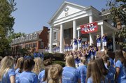 Kansas University's Sigma Kappa sorority members, at top, sing a song to prospective recruits Monday during recruitment week.