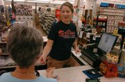 Kate Naramore, who works at Cottin's Hardware, 1832 Mass., makes change for a customer on Wednesday, August 15, 2007. An increase in sales tax is one way the city can raise more money to fund its growing needs.
