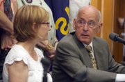 Former Kansas Attorney General Robert Stephan, right, looks at Laura Green, director of the Kansas Compassionate Care Coalition, during a news conference Friday at the Statehouse in Topeka. The group is calling for the legalization of medical marijuana by the Kansas Legislature.