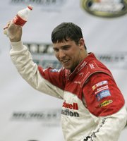 Denny Hamlin celebrates after winning the NASCAR Busch Series Carfax 250. Hamlin won the race Saturday in Brooklyn, Mich.