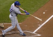 Texas' Travis Metcalf, a Kansas University product, doubles in the second inning of the second game of the Baltimore-Texas twinbill. Metcalf hit a grand slam in the opener and had four more RBIs in the nightcap.