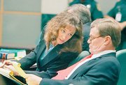 Former astronaut Lisa Nowak, left, talks with one of her attorneys, Donald Lykkebak, on Friday in the courtroom during a hearing at the Orange County courthouse in Orlando, Fla. Nowak, accused of attacking a romantic rival, asked a judge to let her remove her electronic monitoring ankle bracelet.