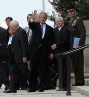President Bush leaves the Pentagon on Friday with, from left, Vice President Dick Cheney, Defense Secretary Robert Gates and outgoing Joint Chiefs Chairman Gen. Peter Pace. Military chiefs conveyed to Bush their concern about a growing strain on troops and their families from long and repeated combat tours. See story, page 3A.