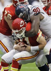 Houston Texans defensive end Mario Williams (90) sacks Kansas City Chiefs quarterback Damon Huard in the third quarter of the Texans' 20-3 victory. Williams also scored a 38-yard fumble-return touchdown in the victory Sunday in Houston.