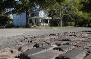 The old brick surface of Ohio Street shows through a section of asphalt in the 700 block. The City Commission voted unanimously, 4-0, to accept a state grant to rehabilitate Ohio Street from Sixth Street to Eighth Street.