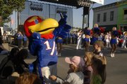 "Get Downtown" brought Kansas University fans and Baby Jay to a street party on Eighth Street between Massachusetts and New Hampshire. The road was closed to traffic Friday evening as fans celebrated with food, drink and music. The KU football team takes on Toledo at 6 p.m. today at Memorial Stadium.
