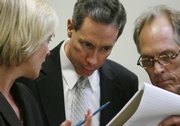 Warren Jeffs is flanked by his attorneys Tara L. Isaacson and Richard Wright at the end of the first day of Jeffs' trial Thursday in St. George, Utah. Jeffs is charged with two counts of rape as an accomplice.
