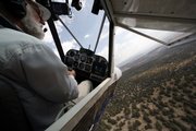 John Morgan flies his plane Wednesday in Minden, Nev. Morgan is one of many searching the area for missing aviator Steve Fossett. After finding a half-dozen old airplane wrecks, crews searching for Fossett focused on new tips about planes actually flying in the area the day his disappeared.