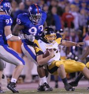 Kansas University defensive lineman James McClinton (93) drags down Toledo quarterback Aaron Opelt. McClinton, undersized for a Big 12 Conference defensive tackle, has made his presence felt this season with his quickness and surprising strength.