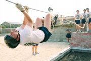 Naval cadet Kris Weible practices a rescue exercise, at the Pensacola Naval Air Station, Fla., on Aug. 1. Weible and his classmates are the last class to graduate from the school, which is consolidating with a training center in Rhode Island.