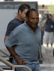 Former NFL player O.J. Simpson is transferred Sunday to the Clark County Detention Center in Las Vegas. A prosecutor in Las Vegas says Simpson "is facing a lot of time" in connection with an alleged armed robbery.