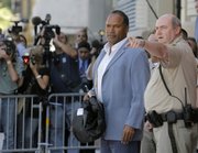 O.J. Simpson leaves the Clark County Detention Center in Las Vegas after he was granted bail. Simpson, charged in an armed robbery case involving sports memorabilia, posted $125,000 bail on Wednesday and returned to his home in Miami.