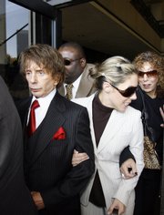 Music producer Phil Spector and his wife, Rachelle Spector, walk out of Los Angeles Superior Court. Spector's trial on murder charges ended in a mistrial Wednesday because of a deadlocked jury.