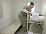 Inmate Vicki Steele, 58, climbs into her bunk in the cell she shares with two others at Metro State Prison in Atlanta. Steele is serving a life sentence for murdering her best friend's husband. She suffers from lupus. The state has also paid for cataract surgery on both eyes and surgery on her ankle and foot.