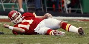 Chiefs quarterback Damon Huard tries to get to his feet after being knocked to the ground in the fourth quarter.