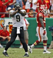 Jacksonville quarterback David Garrard (9) celebrates his three-yard touchdown pass to Dennis Northcutt as Kansas City's Tamba Hali walks off the field. The Jags won, 17-7, Sunday in Kansas City, Mo.