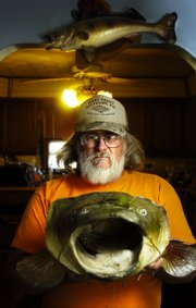 Hoyt resident Michael Corrigan is no stranger to the world of handfishing, otherwise known as "noodling." Here he shows off the head of a 70-pound flathead he caught three years ago on the Red River in Oklahoma.