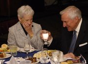 Nancy Kassebaum Baker, left, and Dean Smith share a laugh Thursday at the Bert Nash Community Mental Health Center fundraiser at the Lawrence Holidome.