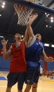 Kansas freshman Cole Aldrich, right, bangs with senior Sasha Kaun during a summer scrimmage at Allen Fieldhouse.