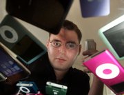 Jeremy Horwitz, shown with a selection of iPods and other Apple devices, wrote a column titled "Customers Ask: Is Apple Going Rotten?" for iLounge, an online publication that covers Apple's digital media offerings. He called the recent iPhone upgrade and resulting disabling of non-Apple software a sign that the company was looking at people who tamper with their products as hackers, not coders. "Apple wants to exert more control over the end user and its products, for better or worse," he said.