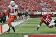 Oklahoma State quarterback Zac Robinson (11) scores against Nebraska in front of Cornhusker Steve Octavien. The Cowboys handed the Huskers their worst home loss in 49 years Saturday in Lincoln, Neb.