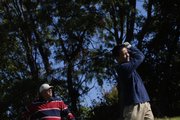 Mike Reeves, left, watches as Jesse Nguyen, both of Lawrence, tees off Thursday, Oct. 11, 2007 on hole one of Alvamar Country Club.