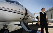 Richard Roberts, president of Oral Roberts University in Tulsa, Okla., boards a plane in Tulsa. Roberts and his wife, Lindsay, were headed to appear on The Larry King Live show Tuesday.