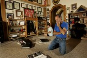 Jim Butler looks over items belonging to his son, Sgt. Jake Butler, in his Wellsville home. Jake's mother, Cindy, is in back. Jake Butler was the first Kansas soldier to die in the Iraq war.