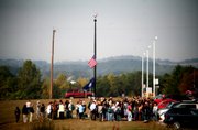 Staunton River High School students gather near the flagpole at their school on Tuesday morning, a day after a classmate who was hospitalized for more than a week with an antibiotic-resistant staph infection died. All schools in the county will be closed today for a thorough cleaning.
