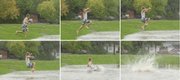 Oliver Hall resident Stephen Krause, 19, a Kansas University freshman, leaps into a basin of cold water that collected next to the residence hall from Wednesday's heavy rain. Scattered storms are expected today.