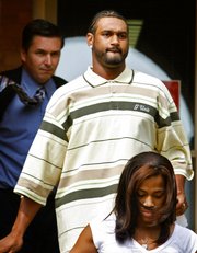Minnesota Vikings wide receiver Koren Robinson, center, leaves the Nicollet County Sheriff's Office after posting bail on a DWI charge in this file photo from Aug. 16, 2006.