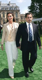 Nicolas Sarkozy and his wife Cecilia are shown in this July 14, 2004, file photo. The couple are separating by mutual consent after 11 years of marriage, the French president's office said Thursday. News of the couple's divorce overshadowed that of a 24-hour French transportation strike.