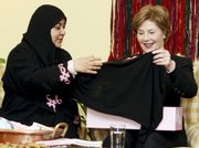 U.S. first lady Laura Bush admires a head scarf presented to her Wednesday by Saudi Dr. Samia al-Amoudi, left, during participation in a "Breaking the Silence" coffee with a cancer survivors group in Jiddah, Saudi Arabia. Bush's trip to Saudi Arabia, her first to the oil-rich kingdom, is part of a regional tour that aims to highlight the need for countries to share their resources and unite in the fight against breast cancer.