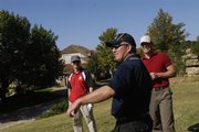 From left, Matthew Cuttell, Scott Clingan and Chris Smith, all soldiers in the Australian Army, laugh as another officer tees off Saturday at Alvamar Golf Course. Foreign military officers stationed at Fort Leavenworth were welcomed to Lawrence by James Schwartzburg of Packer Plastics. Officers from Australia, Korea, France, Germany, Great Britain, Japan, Czech Republic and the Philippines were present.