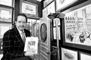 Barry Landau, author of "The President&squot;s Table: 200 Years of Dining and Diplomacy," holds a menu from a Feb. 13, 1905, dinner at the Republican Club in New York celebrating Abraham Lincoln&squot;s signing of the Emancipation Proclamation, part of Landau&squot;s extensive presidential memorabilia collection Oct. 16 at his apartment in New York.