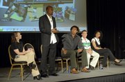 Athlete Alvin Harrison stands to speak about the lures of using performance-enhancing drugs and other obstacles in the way of keeping sports clean. Harisson spoke at the 2007 Anti-Doping Congress on Wednesday in Louisville, Ky. On stage with Harrison were athletes, from left, Tara Cunningham, Genai Kerr, Nathan Piasecki and Kelli White.