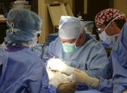 Surgeon James Andrews, center, operates at the Andrews Institute for Orthopedics and Sports Medicine. Andrews has treated several famous athletes at his clinic in Gulf Breeze, Fla.