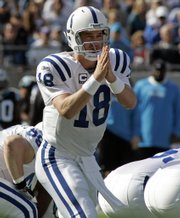 Indianapolis Colts quarterback Peyton Manning directs his team against the Carolina Panthers in this file photo from Sunday's game in Charlotte, N.C. Despite an undefeated record, the Colts are underdogs - at home, no less - Sunday when they play host to the Patriots.