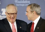 President Bush is introduced by Heritage Foundation President Edwin J. Feulner before speaking Thursday about the global war on terror at the Heritage Foundation in Washington.