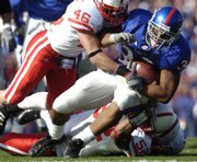 Nebraska's Ben Eisenhart, left, wraps up senior Jayhawk Brandon McAnderson on Saturday, Nov. 3, 2007 at Memorial Stadium.