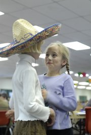 Seven-year-old Laura Heschmeyer, left, and Blythe Landon, right, talk while waiting in line for food Sunday, Nov. 4, 2007 at the 4-H Achievement Celebration at the Douglas County Fairgrounds. Heschmeyer and Blythe are part of the Eudora 4-H club. Heschmeyer participated in entomology and foods, and Landon participated in hand pets and foods.